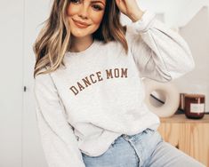 Introducing the "Dance Mom" Sweatshirt: Celebrate the dedication and passion of dance moms everywhere with our handmade custom text sweatshirt. Crafted with love and care, this cozy garment is not just a piece of clothing, but a tribute to the unwavering support and encouragement dance moms provide. Whether it's cheering from the sidelines at competitions or being a source of strength during rehearsals, this sweatshirt is a symbol of appreciation for the tireless dedication of dance moms. Perfec Casual Relaxed Fit Sweatshirt For Dance Class, Dance Mom Gifts, Dance Teacher Gifts, Dancer Gift, Dance Teachers, Dance Mom, Mom Hoodies, Dance Teacher, Dance Competition