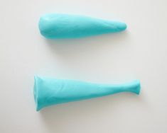 two blue candy sticks sitting on top of a white table