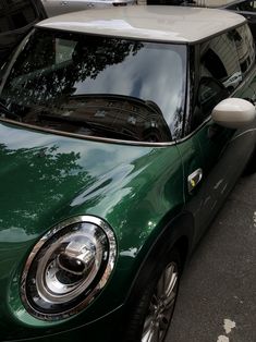 a green car parked on the side of the road