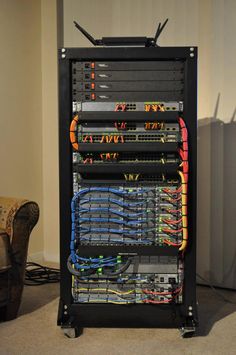 the rack is full of many different colored wires and cables, all connected to each other