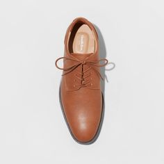 From formal meetings and events to family functions, these Leo Oxford Dress Shoes from Goodfellow & Co™ are a great pick to complete your ensemble. These medium-width shoes feature a cushioned footbed for comfy wear, making them great for both special occasion and everyday wear. With a sleek upper with stitched detailing and a lace-up front, they're perfect for creating a sharp, stylish look. Goodfellow & Co™: Where style & fit are always in good company. Tan Mens Dress Shoes, Classic Closed Toe Dress Shoes With Cushioned Footbed, Fall Semi-formal Dress Shoes With Closed Toe, Semi-formal Fall Dress Shoes With Closed Toe, Formal Fitted Synthetic Oxfords, Elegant Synthetic Lace-up Oxfords, Classic Fitted Synthetic Oxfords, Brown Formal Leather Shoes With Cushioned Footbed, Formal Brown Leather Shoes With Cushioned Footbed