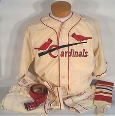 a baseball uniform is displayed on a mannequin's head, with other items around it