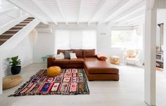 a living room filled with furniture and white walls