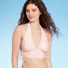 Longline Halter Bikini Top In A Light Pastel Floral Print. Made From Opaque Fabric With Stretch And A Full Lining. Halter-Style Top Ties Behind Neck To Secure, While Back Band Is Solid. Removable Cups Offer Customizable Coverage, While Side Cinch Ties Allow For Adjusting The Length Of The Longline Design. Pink Spring Tankini With Built-in Bra, Pink Fitted Tankini For Spring, Pink Summer Halter Top With Built-in Bra, Pink Halter Neck Tankini For Summer, Spring Triangle Top Tankini With Built-in Bra, Spring Pink Tankini, Bra-friendly, Spring Pink Tankini, Bra Friendly, Pink Halter Neck Swimwear With Built-in Bra, Pink Halter Neck Tankini For Pool