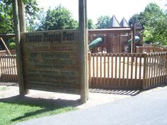 there is a sign for the children's play area in the park that says, your playground post