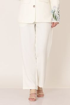 White blazer with floral placement embroidery on the sleeves. Paired with a pant. - Aza Fashions Elegant White Pants With Floral Embroidery, Floral Embroidered Pants For Spring Workwear, Elegant Floral Embroidery Trousers, Floral Embroidered Straight Pants For Workwear, Floral Embroidery Straight Pants For Workwear, Floral Embroidery Straight Pants For Work, Floral Embroidered Bottoms For Workwear In Spring, Floral Embroidered Bottoms For Spring Workwear, Spring Floral Embroidered Bottoms For Work