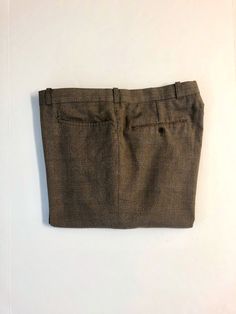 "Vintage Men's 80's Brown, Plaid, Straight Leg, Pants (W40) 1097 These Men's Pants come in a brown polyester/viscose blend and has a plaid print in blue and orange with a zipper fly, five pockets, and straight leg fit with a pressed seam. The pants are heavy weight and do not stretch and are not lined. 65% Polyester 35% Viscose *These pants are in like new condition. *If shipped within the US, they will go Priority Mail for a quick delivery! Size: (W40 x L32) Waist: 40\" Hips: 44\" Inseam: 33\" Classic Brown Bottoms With Hip Pockets, Brown Bottoms With Welt Pockets, Tailored Brown Bottoms With Tapered Leg, Brown Tailored Tapered Leg Bottoms, Classic Brown Tapered Leg Bottoms, Tailored Brown Tapered Leg Pants, Brown Bottoms With Welt Pockets For Fall, Brown Flat Front Pants With Pockets, Brown Flat Front Dress Pants With Pockets