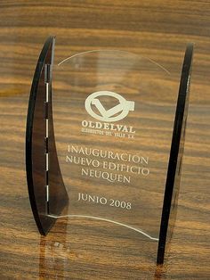 an award is displayed on a wooden table