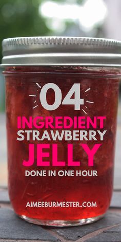 a jar of strawberry jelly sitting on top of a wooden table with the words, ingredient strawberry jelly done in one hour