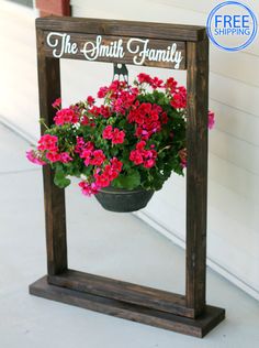 a potted plant sitting on top of a wooden frame that says the smith family