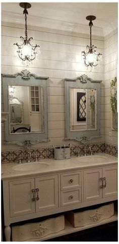 a bathroom with two sinks and three mirrors