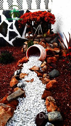 a garden filled with lots of rocks and flowers