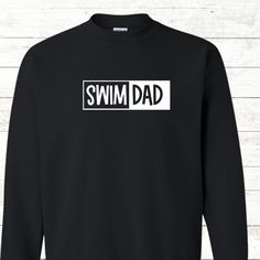 This Swim Dad adult sweatshirt is the perfect way to show off your pride and cheer on your favorite swimmer. The bold white text on the front looks great and has the option for adding a personalized message on the back. Free shipping makes it a great gift - perfect for holidays, birthdays, or any celebratory occasion. Design also available in tees, totes, aprons, and hoodies: Tees: Totes: Hoodies: Cotton Sweatshirt With Name Print For Sports Season, Sporty Letter Print Sweatshirt For Cheerleading, Basic Sweatshirt With Letter Print, Black College Sweatshirt With Name Print, Sporty Cotton Sweatshirt With Name Print, Sporty Crew Neck Sweatshirt With Name Print, Sporty Black Sweatshirt With Name Print, Black Sporty Sweatshirt With Name Print, Swim Mom