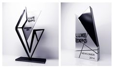 two different views of a black and white award with the words luke expo on it