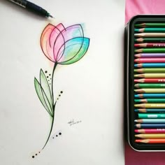 colored pencils are next to a drawing of a flower