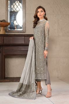 Pakistani Long Kameez and Capri Party Wear in Greyish Black is a comforting combination on grey, this is a mesmerizing attire featuring blissful embroideries in silver hued sequins. Paired with a contrast light grey dupatta and complementing dark grey pallus, this ensemble is brought to life and is a must have to up your style game this season. Detailed Description: SKU: PB0034 Detailing: Embroidery, Threads, Floral designs Color: Grey Fabric: Chiffon Design: Fully Embroidered dress Event: Festi Capri Party, Pakistani Bridesmaids, Long Kameez, Net Sleeves, Wedding Dresses Pakistani, Wedding Frocks, Net Shirt, Pakistani Party Wear Dresses, Pakistani Boutique