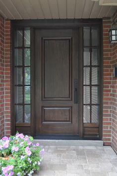 the front door is brown and has flowers in it