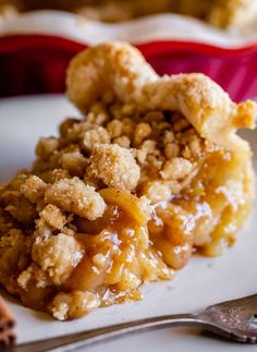 a piece of apple crisp pie on a plate with a fork and spoon next to it