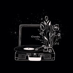 an old record player with flowers on it and a laptop in the background that says, i love music