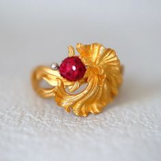 Personal Collection Gold Fish Ring. This is a super finely made piece of art. The body of the fish is of is super sparkly texture that glitters✨ under light and the band is in a velvety silky gold texture that reminds me of the most lovely ribbons. 🎀  💍Condition: Brand New & Custom Designed  💍Size: US 5-5.5 not sizable 🥲 ⭐️Metal: Solid 18K Yellow Gold ♥️Two types of gold textures super unique design. ⭐️Center Stone: 1mm rubies on the fish's head 💎Measurement: 14*14mm This item will be sent Exquisite 14k Gold Ruby Ring, Elegant 14k Gold Fish-shaped Jewelry, Elegant 22k Gold Ruby Ring Gift, Elegant 22k Gold Ruby Ring, Elegant Fish-shaped Formal Jewelry, Exquisite Gold Ruby Ring With Prong Setting, Ring With Ruby, Fish Ring, Types Of Gold