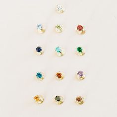 six different colored stones are arranged in the shape of a circle on a white surface