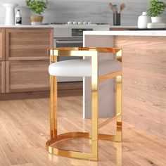 a white and gold counter top in a kitchen next to a wooden floor with potted plants on it