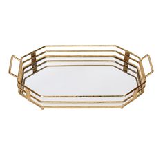 gold metal and glass serving tray with geometric lines on the sides, set against a white background