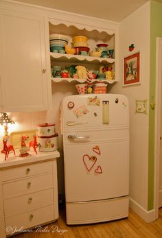 a white refrigerator freezer sitting inside of a kitchen