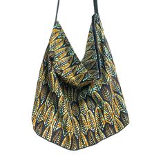 Pretty boho ethnic chic tote bag, handmade and eco-friendly, with handles and bottom made from recycled Italian leather. This handmade bag features a Khaki/Bronze leaf-shaped African graphic print on a Black background in 100% African Ankara cotton. Lined with black cotton canvas, it features a magnetic closure for added security.  Internal pocket matching the wax print and leather ties attached to a carabiner are also included, so you'll never lose your keys again.  Dimensions: Height without h Bohemian Reversible Shoulder Bag, Bohemian Reversible Hobo Bag For Daily Use, Bohemian Reversible Hobo Tote Bag, Bohemian Reversible Hobo Bag For Everyday Use, Bohemian Reversible Hobo Bag For Travel, Green Bohemian Hobo Bag For Everyday, Reversible Bohemian Shoulder Bag, Bohemian Ethically Sourced Shoulder Bag For Everyday Use, Bohemian Reversible Rectangular Shoulder Bag