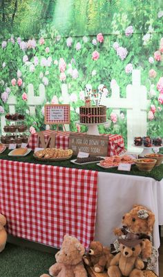 teddy bears sitting in front of a table with food on it