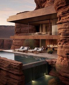 an outdoor swimming pool surrounded by rocks and water