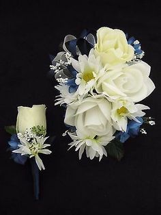 two bouquets of white and blue flowers on a black background