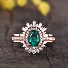 an emerald colored stone surrounded by white diamonds