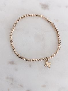 This pretty bracelet is made with 14k gold filled beads and gold filled block initial. Perfect on its own or stacked with your favs! Select initial from drop down menu. All these bracelets are made to fit a 6.5 inch wrist. If you prefer a specific size, please indicate in the notes section. Unsure of sizing...Measure your wrist with a ruler and string in the location you would wear the bracelet. Keep it fitted and I'll add the extra room for comfort. If you measure 6 inches then put 6 inches in Bracelet With Initials, Permanent Bracelet, Initial Bracelet Gold, Initial Bracelet, Pretty Bracelets, Gold Initial, Block Lettering, Extra Room, Girly Jewelry