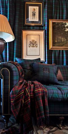 a living room filled with furniture and framed pictures on the wall above it's headboard