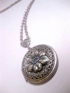 Silver Flower Locket The Locket: - Centered with a real flower in resin dome - Measures 32mm round (1.25 inches round) The connector and locket together hangs down approximately 2 inches from necklace chain. Chain: - Silver Plated - YOU CHOOSE YOUR CHAIN LENGTH FROM DROP DOWN MENU TOOL ☻☻ TO see MORE of our LOCKET NECKLACEs (while supplies last): https://www.etsy.com/shop/FashionCrashJewelry/search?search_query=locket&order=date_desc&view_type=gallery&ref=shop_search ☻ Link To My Ent Silver Flower Locket Jewelry, Victorian Sterling Silver Round Locket Necklace, Elegant Sterling Silver Flower Pendant Locket Necklace, Ornate Silver Locket Necklace Gift, Silver Flower-shaped Locket Jewelry, Flower Necklace Silver, Flower In Resin, Locket Necklaces, Custom Chain