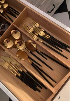 an open drawer with spoons and forks in it