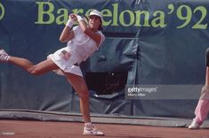 a female tennis player is swinging her racket at the ball during a match in barcelona, spain