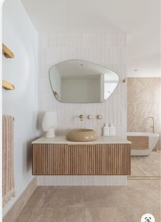 a bathroom with a sink, mirror and bathtub