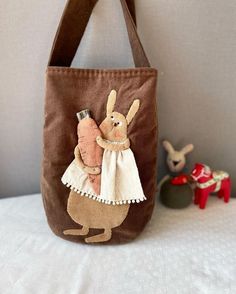 a brown bag with an image of a rabbit holding a carrot on it's shoulder