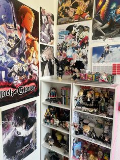 a room filled with lots of anime posters on the wall and shelves full of toys