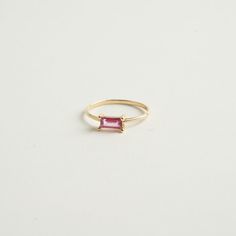 From our birthstone collection this exquisite natural ruby features a rare and delicate pink hue, radiating elegance and sophistication.  Celebrate the vibrancy of July with this stunning emerald-cut ruby crafted in 14K gold. Materials:  14K Solid gold .35 ct. Natural Ruby .79 Gold grams    Care Instructions: Storage: Store your jewelry in a cool, dry place, preferably in a fabric-lined jewelry box or pouch. Keep pieces separate to avoid scratching. Avoid Chemicals: Keep your jewelry away from harsh chemicals, such as bleach, chlorine, and household cleaners. These can damage metals and dull gemstones. Regular Cleaning: Clean your jewelry regularly with appropriate methods to maintain its brilliance and prevent buildup of oils and dirt. Timeless Emerald-cut Ruby Ring, Pink Emerald Cut Ruby Ring In Fine Jewelry, Emerald Cut Pink Ruby Ring In Fine Jewelry Style, Elegant Emerald Cut Tourmaline Jewelry, Luxury Ruby Baguette Cut Jewelry, Baguette Cut Tourmaline Jewelry For Weddings, Pink Ruby Ring Fine Jewelry Birthstone, Pink Emerald Cut Tourmaline Jewelry, Pink Emerald-cut Tourmaline Jewelry