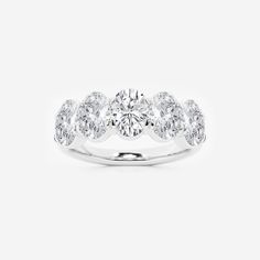 a three stone diamond ring on a white background