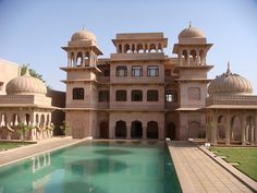 a large building with a pool in front of it