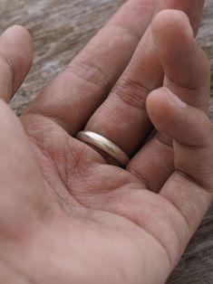 What does it feel like to love without a safety net? To love without holding back? She doesn’t hold the answers, but she told you that nevertheless, she’d choose love ten times over. This wedding ring features a subtle grained texture that reminds me of soft stardust. You can actually feel this sandblasted finish with the tip of your fingers. The great thing about this finish is that it won't easily scratch, which is bound to happen over the lifetime of any ring. Please note that your ring will Sterling Silver Promise Band, Minimalist Sterling Silver Wedding Bands, Minimalist Wedding Bands In Sterling Silver, Minimalist Handmade Engraved Promise Ring, Minimalist Silver Engraved Promise Ring, Minimalist Handmade Engraved Ring For Wedding, Simple Silver Stackable Wedding Rings, Simple Silver Stackable Rings For Wedding, Stardust Wedding