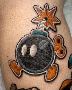 a close up of a person's leg with tattoos on it and an image of a bowling ball