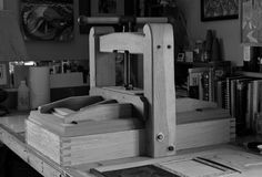 a workbench made out of wood in a black and white photo with books on the table