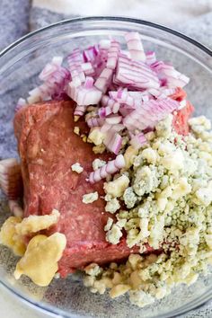 meat, onions and other ingredients in a glass bowl