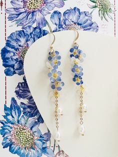 Introducing our Blue White Ombré "Forget Me Not" Flowers with Natural Pearl Drops Earrings.  These long, dangling earrings are a perfect blend of elegance and handmade artistry, featuring delicate ombré forget-me-not flowers transitioning from blue to white.  Each flower is meticulously crafted by hand, ensuring a unique piece for every wearer.  The earrings are adorned with natural pearl drops, adding a touch of timeless beauty and sophistication.  Ideal for brides seeking "something blue" for Blue Summer Wedding Jewelry, White Ombre, Natural Pearl, Dangling Earrings, Forget Me Not, Something Blue, Pearl Drop Earrings, Pearl Drop, Natural Pearls