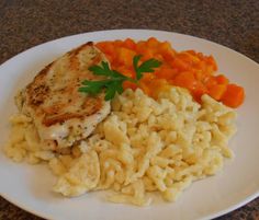 chicken, rice and carrots on a white plate